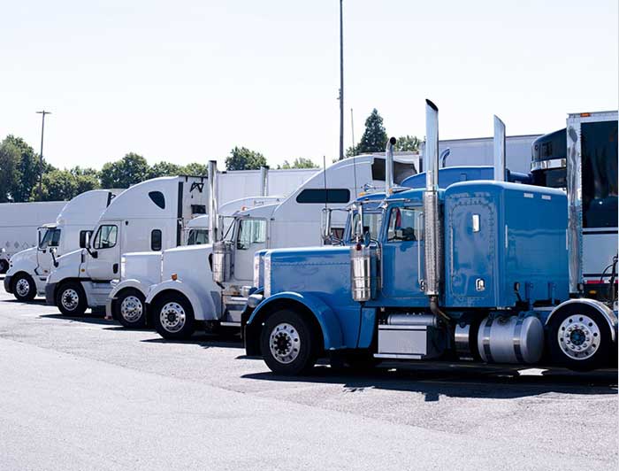 Commercial trucks lined up at an agle.