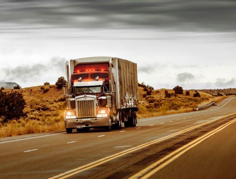 Image of a red and black truck during on a road