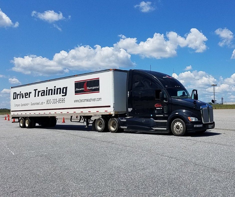 GDA and Stevens Transport semi truck parked in asphalt training yard
