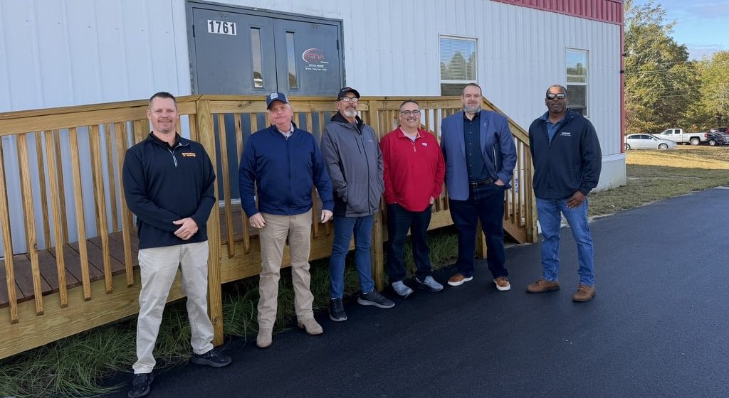 Georgia Driving Academy Recruiters standing in front of campus building