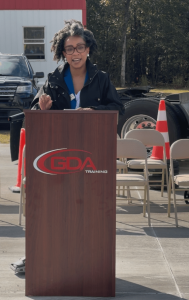 Angelique McClendon speaking at a podium