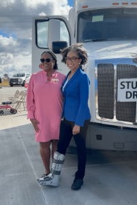 Angelique McClendon and DDA Commissioner standing in front of semi truck